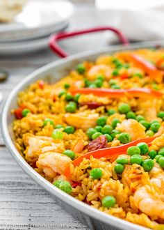 a pan filled with rice and peas on top of a table