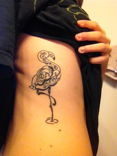 a woman with a tattoo on her stomach is holding onto the side of her body