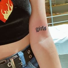 a woman with a tattoo on her arm that says girls