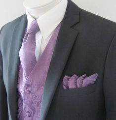 a man in a suit with a purple flower on his lapel