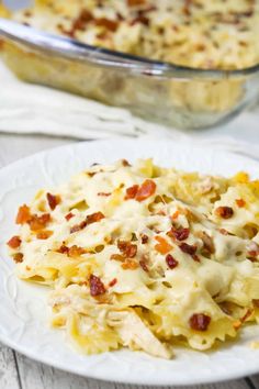 a white plate topped with pasta covered in cheese