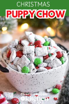 a bowl filled with christmas puppy chow on top of a table next to candy canes