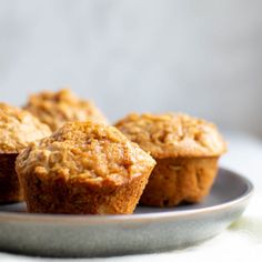 three muffins sitting on a plate with white background