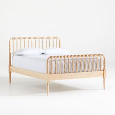 a wooden bed frame with white sheets and pillows on it, against a plain background