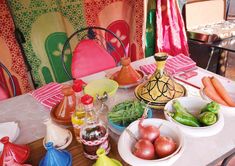 the table is covered with many different types of vegetables and condiments on it