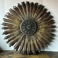 an antique clock made out of metal sticks