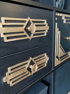 two black drawers with gold accents on them