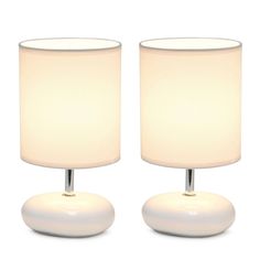 two white lamps sitting next to each other