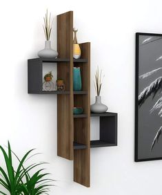 a wall shelf with some vases and plants on it