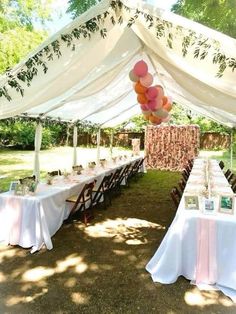 an outdoor tent with tables and chairs set up for a party