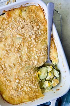 a casserole dish with a spoon in it on a blue towel next to a keyboard