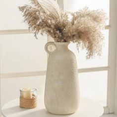 This set of two modern handmade ceramic vases in off-white with a matte finish is perfect for any decor. Their sculptural design with a frosted sand texture adds elegance to your home. Use them as centerpieces for fresh flowers, dried florals, or pampas grass. Ideal for living rooms, bedrooms, dining areas, and offices, these vases are a stylish addition to any space. They also make a thoughtful gift for weddings, housewarmings, and other special occasions. Lark Manor™ | Lark Manor™ Handmade Mo… Pampas Vase, Vase Pampas, White Bungalow, Mini Cottage, Sand Texture, Farmhouse Vase, Boho Vase, Earthenware Ceramics, Rustic Vase