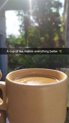 a cup of tea makes everything better with the sun shining in the window behind it