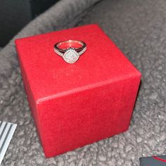 a red box with a diamond ring on it