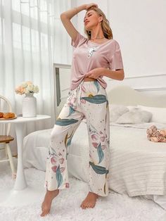 Elevate your comfort with our Floral Print Tee And Pants Pajama Set. Experience the joy of our exquisite cartoon and floral patterns, beautifully complemented by a delicate knot detail. Designed for relaxation, this 2-piece set features a round neck, short sleeves, and a regular fit. Crafted from high-quality knitted fabric with medium stretch, it offers both style and ease. Specifications: Pattern Type: Cartoon, Floral Type: Pant Sets Neckline: Round Neck Details: Knot Sleeve Length: Short Slee Casual Floral Print Sets For Sleepover, Casual Floral Print Sleepover Sets, Casual Pink Floral Print Sleepwear, Pink Floral Print Lounging Set, Floral Print Sleepwear For Pajama Party, Printed Loungewear Set With Long Pants, Printed Sets For Loungewear With Long Pants, Casual Floral Print Lounging Sets, Casual Matching Set Bottoms For Pajama Party