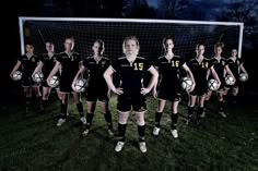 a group of women in soccer uniforms standing next to each other with balls on their feet