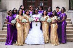 a group of women standing next to each other in front of a building holding bouquets