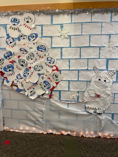 a paper mache christmas tree made out of white and blue plates on a brick wall