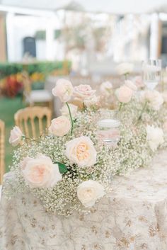 the table is set up with flowers and candles for an elegant wedding reception or special event