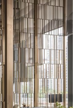 the interior of an office building with large windows and wooden slats on the walls