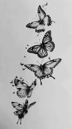 three butterflies flying in the air with one on its back and another on its side