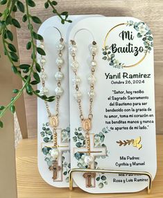 the earrings are on display in front of a card with an image of a cross