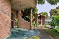 an outside view of a brick building with green plants