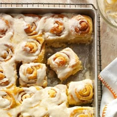 a pan filled with cinnamon rolls on top of a table