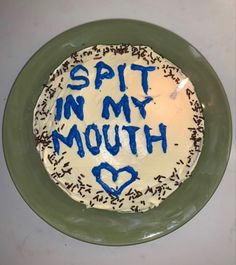 a birthday cake that says spit in my mouth on top of a plate with sprinkles