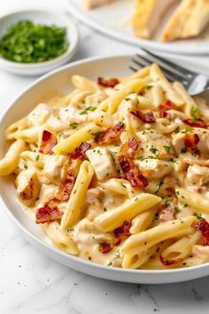 a white plate topped with pasta and chicken