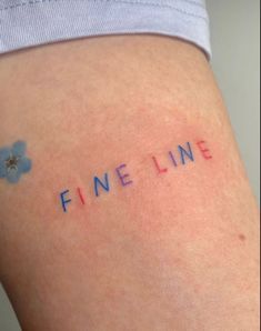 the word fine line written on someone's thigh