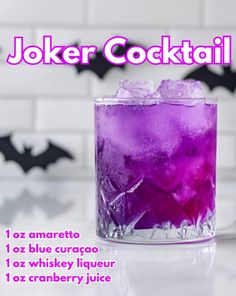 a purple drink in a glass with ice on the rim and bats behind it, text reads joker cocktail