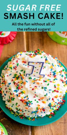 a cake with white frosting and sprinkles sitting on top of a green plate