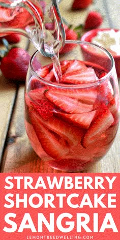 strawberry shortcake sangria in a glass with strawberries on the side and text overlay that reads, strawberry shortcake sangria