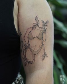 a woman with a tattoo on her arm holding an apple and leaves in her hand