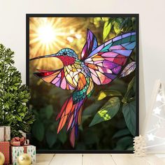 a colorful hummingbird flying through the air next to a christmas tree with presents on it