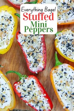 stuffed bell peppers with cheese and black pepper on top, sitting on a cutting board