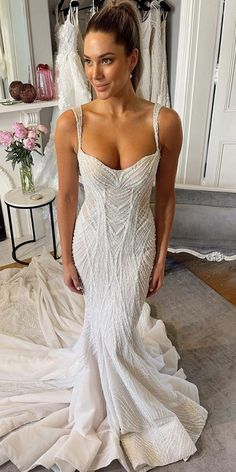 a woman in a wedding dress posing for the camera