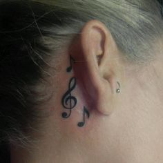 a woman's ear with musical notes on it