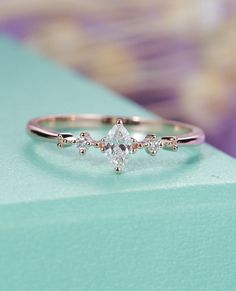 a diamond ring sitting on top of a blue box