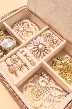 an open jewelry box filled with lots of different items