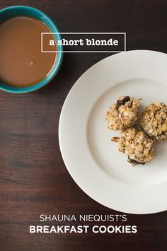 a white plate topped with cookies next to a cup of coffee