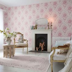 a living room filled with furniture and a fire place in front of a wallpapered wall