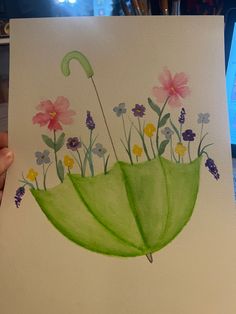 a drawing of a green umbrella with flowers in the bottom and pink daisies on top