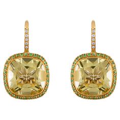 11.52 Carat Natural Cushion-Cut Lemon Quartz, Tsavorite, and Diamond Earrings: A beautiful pair of earrings, it features 2 cushion-cut natural lemon quartz weighing 11.52 carat surrounded by white round-brilliant cut tsavorites weighing 1 carat topped by round-brilliant cut diamonds weighing 1.63 carat. The quartz possesses a soothing brownish greenish yellow colour saturation, with excellent brilliance and lustre, as well as exceptional clarity. The tsavorites and diamonds too are of fine quali Chrome Tourmaline, Color Change Sapphire, Diamond Tops, Diamond Chandelier Earrings, Diamond Chandelier, Gold Chandelier Earrings, Flower Engagement Ring, Natural Cushions, Ruby Beads