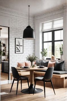 a dining room table surrounded by black chairs