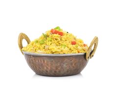 a metal bowl filled with rice and vegetables