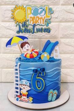 a birthday cake with an image of a boy in the pool on top and beach decorations