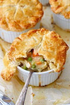 a close up of a pie in a dish with a spoon on the table next to it