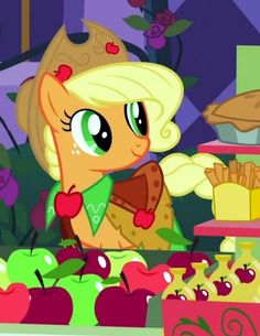 the pony is standing in front of an assortment of apples